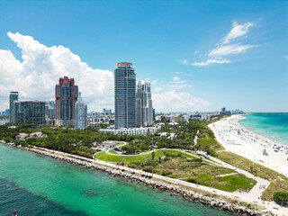 Fototapeta premium Miami beach, ocean drive summer cityscape. Miami Beach, South Beach, Florida, USA. Coastline, aerial view. Aerial view of high skyscrapers and ocean, Miami Beach, Florida, United States.