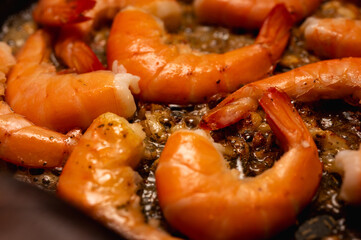 fried red shrimp in a pan, cooking fish dishes, fish food, selective focus, background