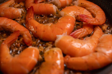 fried red shrimp in a pan, cooking fish dishes, fish food, selective focus, background