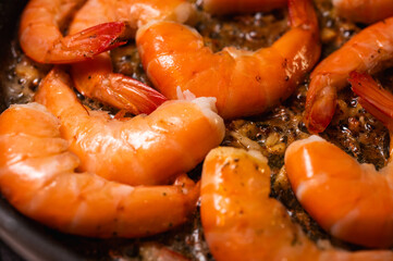 fried red shrimp in a pan, cooking fish dishes, fish food, selective focus, background