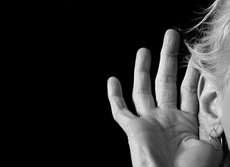 deaf woman suffering from deafness and hearing loss on gray background with people stock image...