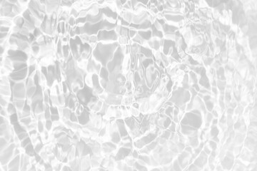 White water with ripples on the surface. Defocus blurred transparent white colored clear calm water surface texture with splashes and bubbles. Water waves with shining pattern texture background.