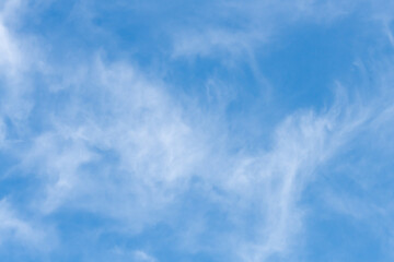 The afternoon sky with white soft high cirrus clouds