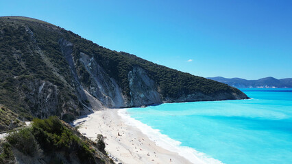 Breathtaking Stunning Beach View Featuring Crystal Clear Water and Scenic, Lush Green Hills