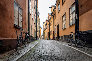 Sweden quaint cobblestone street in picturesque Gamla Stan, Stockholm's oldest neighborhood. Parked...