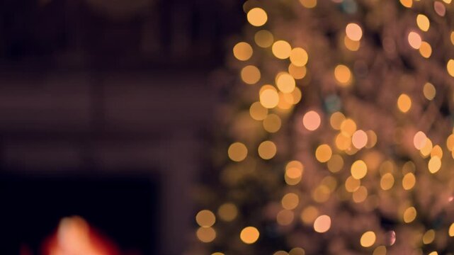 Christmas tree in cosy decorated living room at home with fireplace. December winter mood. Blurred out of focus background video for holiday ads and offer.