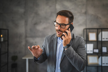 furious and worried businessman talk on mobile phone in modern office