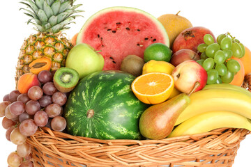 Many different fresh fruits in wicker basket isolated on white