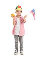Cute little boy with pumpkin and USA flag on white background. Thanksgiving Day celebration