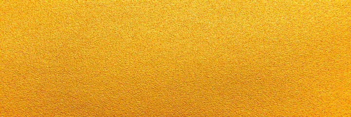 Gold texture background. Panorama yellow gold sand texture background. Panoramic bright grains gold textured