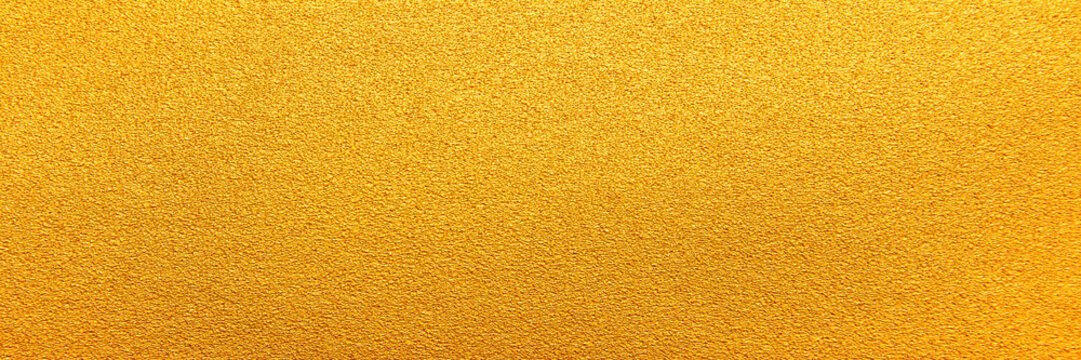 Gold texture background. Panorama yellow gold sand texture background. Panoramic bright grains gold textured