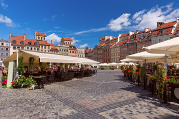 Market square with beautiful buildings and street cafes in the old town on a sunny summer day, Warsaw, Poland