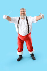 Cool Santa Claus conductor with wand on blue background