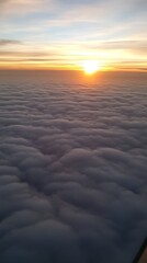 Aerial panorama of a vast blue sky with fluffy white clouds, framed by an airplane window