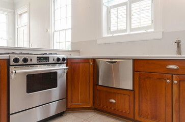 Fototapeta premium Corner Stove And Dishwasher In Contemporary Kitchen