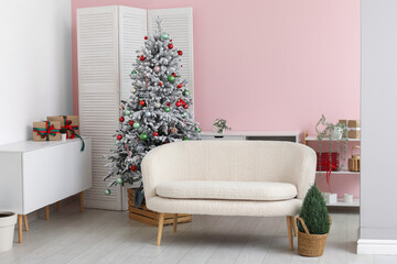 Stylish interior of living room with decorated Christmas tree and gifts