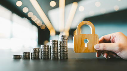 The symbol of the lock and pile of money represents the stability of the currency and interest on...