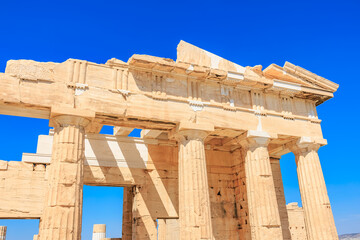 The building is old and has a lot of columns, the Acropolis of Athens