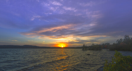 Sunset over a lake with clouds in the sky