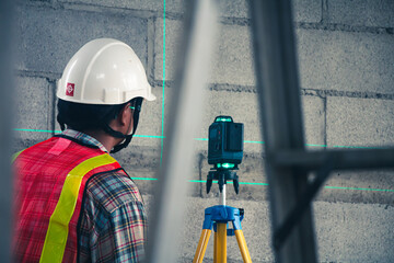 The engineer uses a laser level to ensure accurate water alignment during the quality inspection.