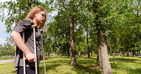 determined girl, navigating the park with her crutches, exudes an air of resilience and empowerment, her gaze fixed forward as she embraces her journey.