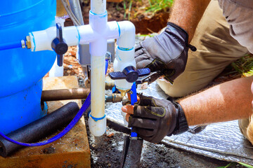 Plumber service assembles connection between water well house water system