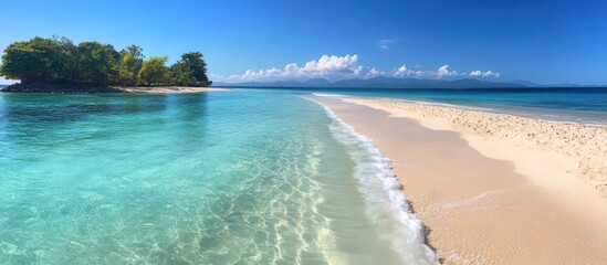 A small tropical island with white sand beach and turquoise water.