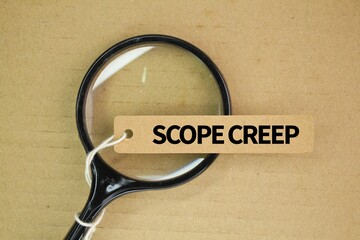 magnifying glass and a paper tag with the word Scope Creep. continuous or uncontrolled growth in a...
