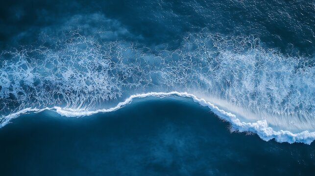 Aerial View of a Blue Ocean Wave Crashing