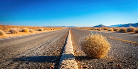 Desolate desert road with rolling tumbleweed