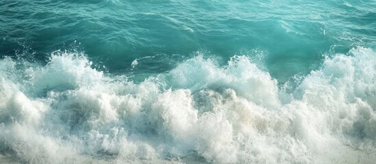 Fototapeta premium Close-up of foamy waves crashing on a turquoise ocean.