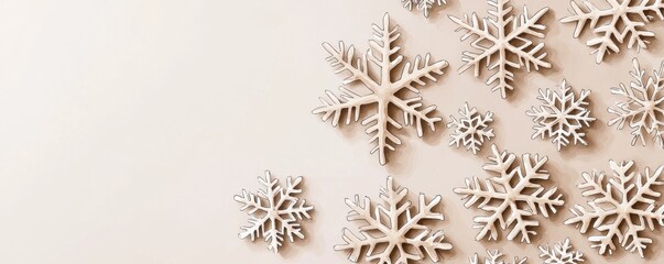 Decorative wooden snowflakes on a soft pastel background.