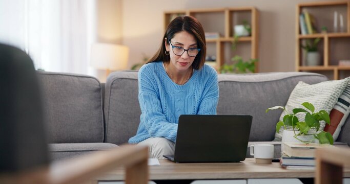 Laptop, working and woman in home with freelancer, writer and editor for website. Living room, sofa and planning digital article and post with technology and reading for story research in morning - Powered by Adobe