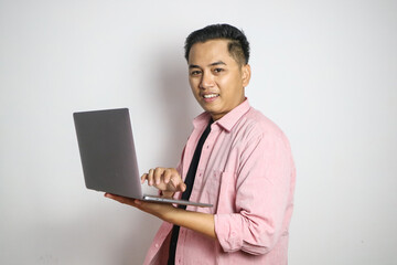 Young Asian business man using laptop computer and sitting on white chair isolated on white background