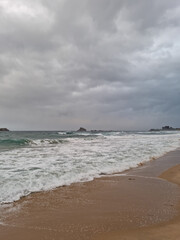 
This is a beach scene covered in dark clouds.