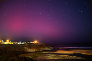 Southern Aurora lights up the night sky in stunning display over a calm beach on the Australian coastline near Adelaide