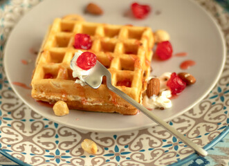 Homemade Belgian Waffle is ready to eat. on dinner plate with berries and nuts. Easy Prepare Pancake, Versatile Breakfast. Shallow focus. the concept is easy to cook. homemade dessert for breakfast