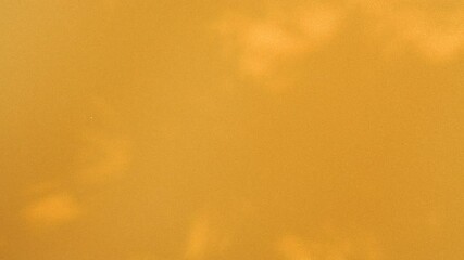 Abstract background, tree branch leaves silhouette shadows motion on golden wall - Powered by Adobe