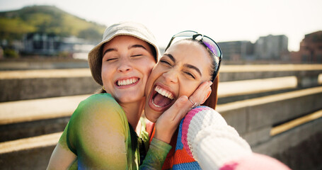 City, selfie and excited women hug, smile and laugh with cool streetwear on bridge together. Social...