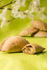 Meat Pies on a lime green background with spring flowers © Cavan