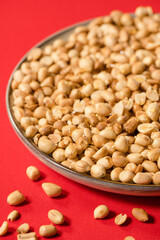 Nuts with honey drizzled on them against a red background