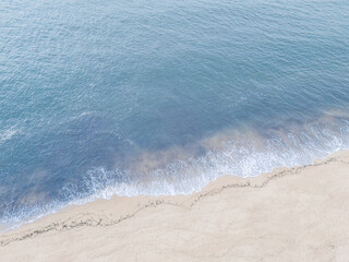 Waves gently lapping onto the sandy shore in Newburyport, MA