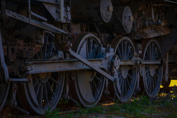 Vintage Train Undercarriage: Weathered Beauty of Industrial Engineering. Close-up of Deteriorating Steam Engine Reveals Complex Wheel Assembly