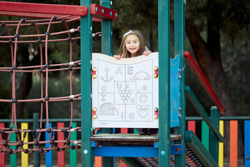 Smiling Girl Enjoying Play Structure at Colorful Playground