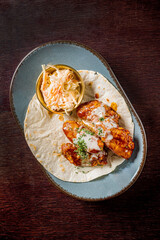 chicken wings with sauce and salad
