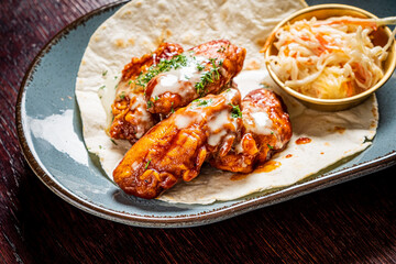 chicken wings with sauce and salad