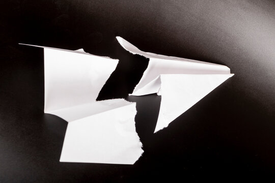paper plane in the middle it is torn. concept of breakdown, accident, crash, does not work. close-up.