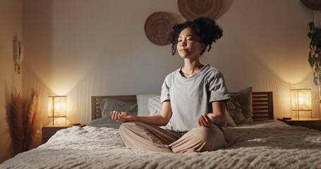 Woman, meditation and yoga in home for mindfulness, fitness and holistic health on bed with peace....