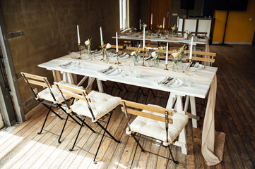 Elegant neutral coloured wedding table scape with flowers and candles