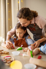 Fototapeta premium Happy family mother and daughter in aprons making Christmas cookies together while cooking